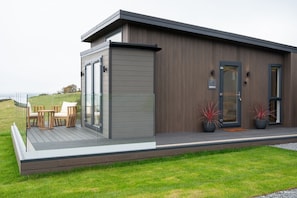 A modern house with a deck, a door, and a window. - Barlocco -  a lodge that sleeps 2 guests  in 1 bedroom (Isles of Fleet Retreat, Gatehouse of Fleet)
