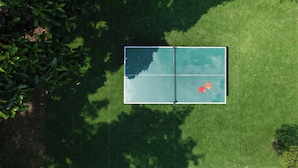Vista aérea de una cancha de tenis con dos raquetas colocadas sobre ella.