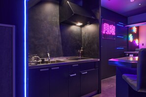 A modern kitchen with a built-in stove, a sink, and cabinets. - Tsukian (Osaka)