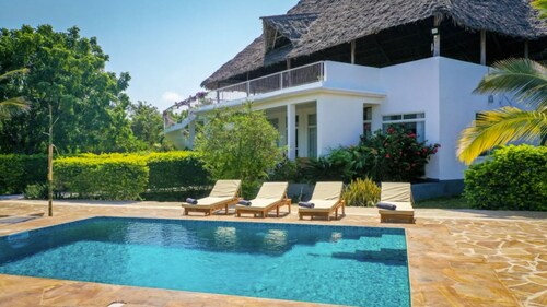 Breezy Coastal Luxury: Modern Villa Living in Fumba Town, Zanzibar