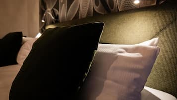 Un letto con una testiera verde e dei cuscini.