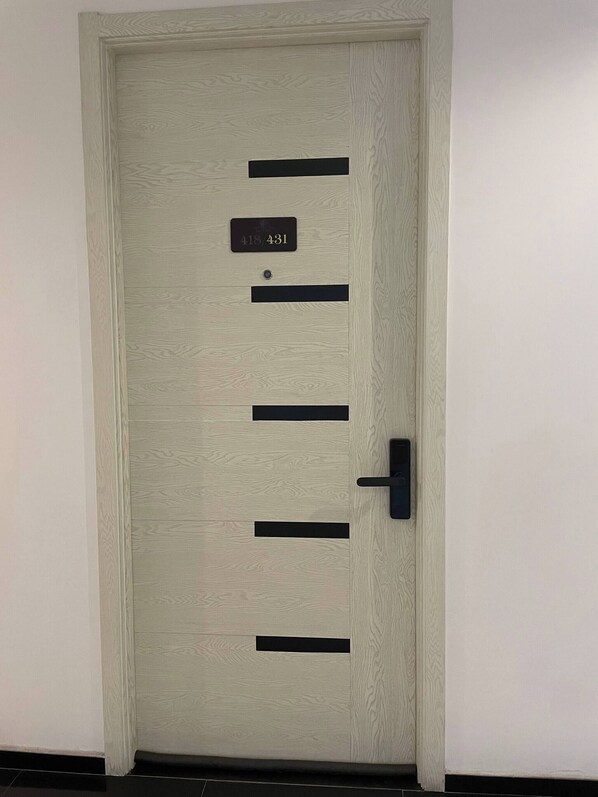 A door with a number plate, a handle, and a keyhole.