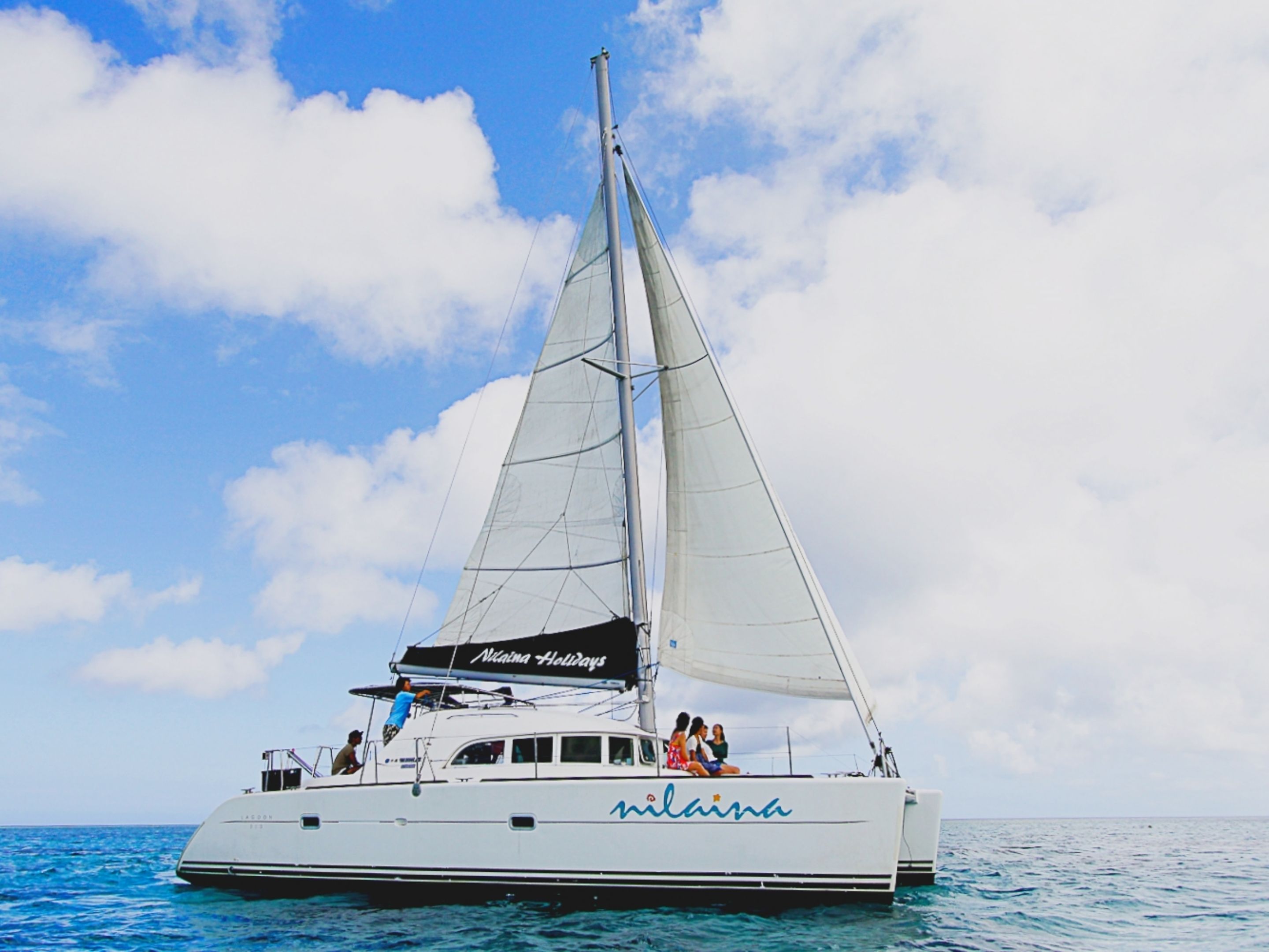 A sailboat with the name 'Nina' on its side, sailing on the water.