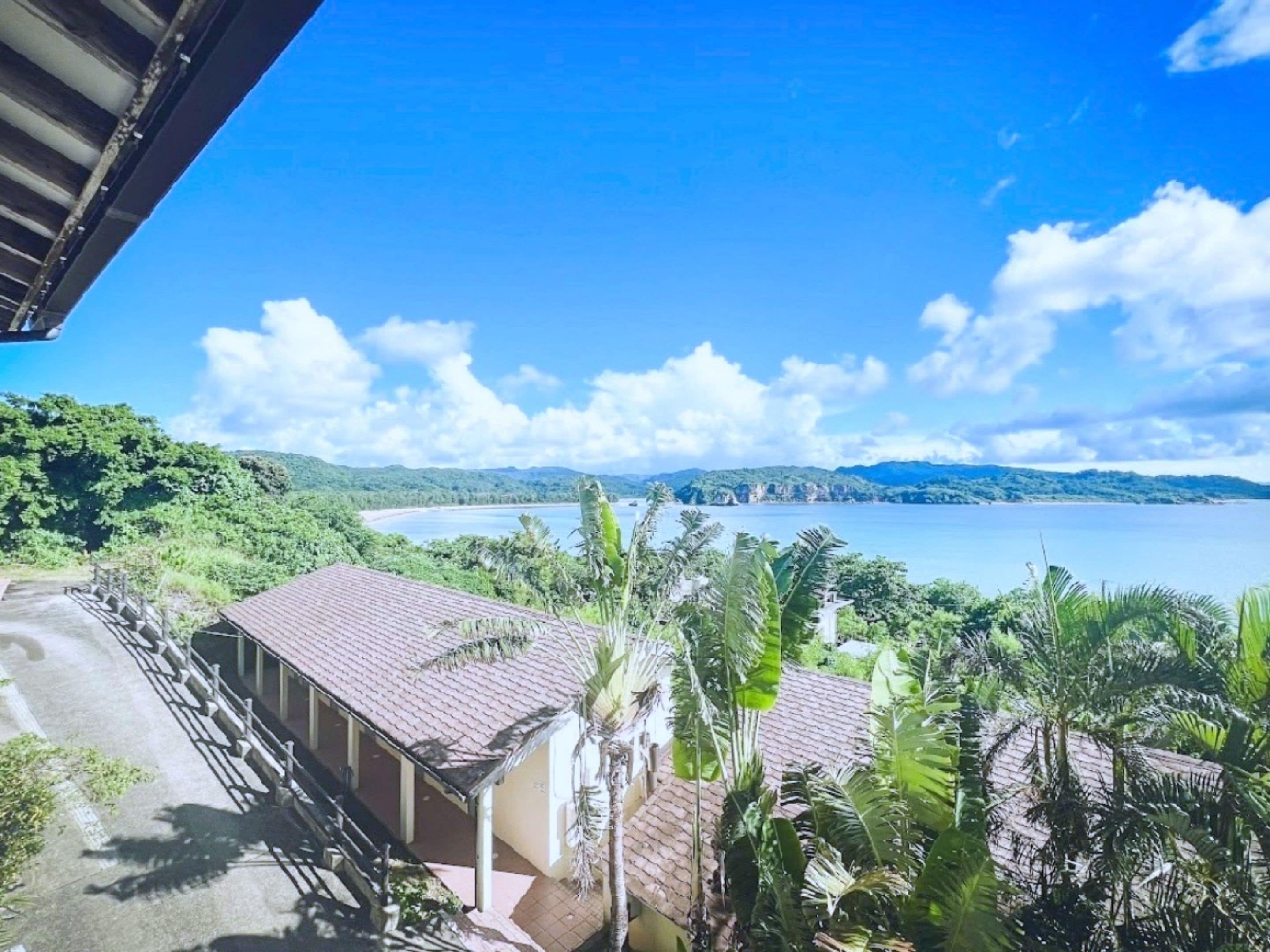 A coastal view with a building and a road leading to it.
