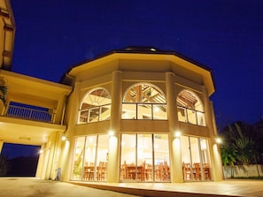 A building with a large central atrium, multiple windows, and a balcony.