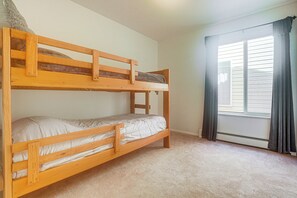 A bunk bed room with a window and curtains. - Grand Junction Home w/ Patio: Shop, Dine & Hike! (Grand Junction)