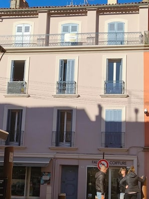 A multi-story building with balconies, a visible storefront, and a no parking sign. - Omnia. Air conditioned charm in historic Frejus. (Fréjus)