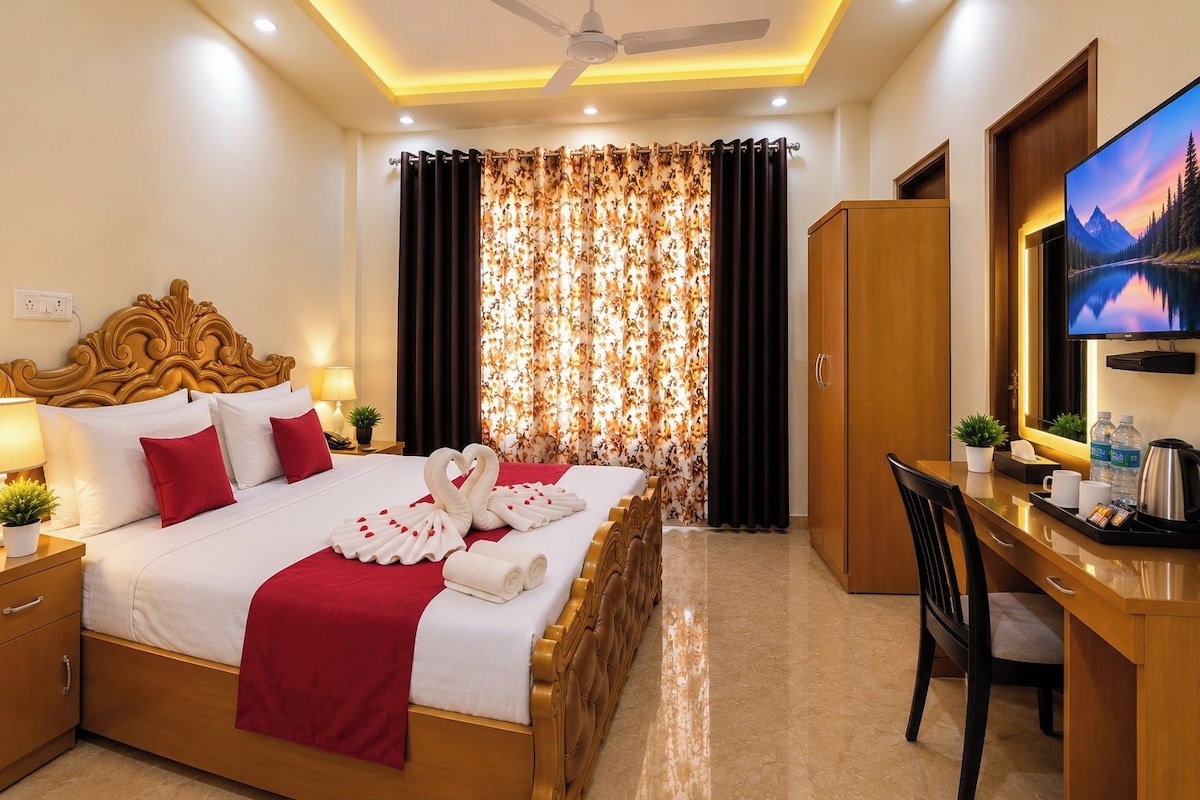 A hotel room with a bed, a desk, a television, and a wardrobe.