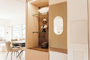 Ein modernes Interieur mit Essbereich, einer Wand mit Holzverkleidung und einer dekorativen Hundfigur.