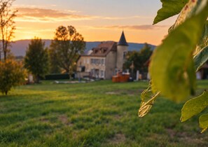 A rural landscape with a church and residential buildings.