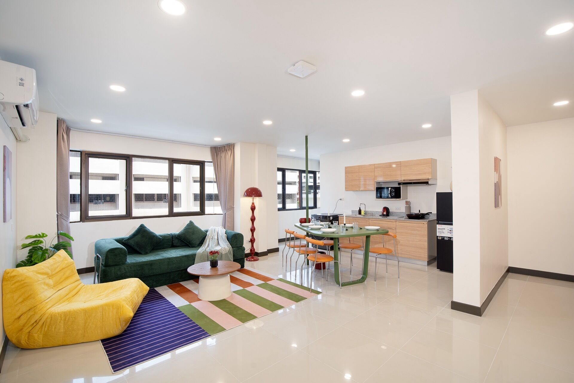 A modern apartment with a living area, dining space, and kitchen.