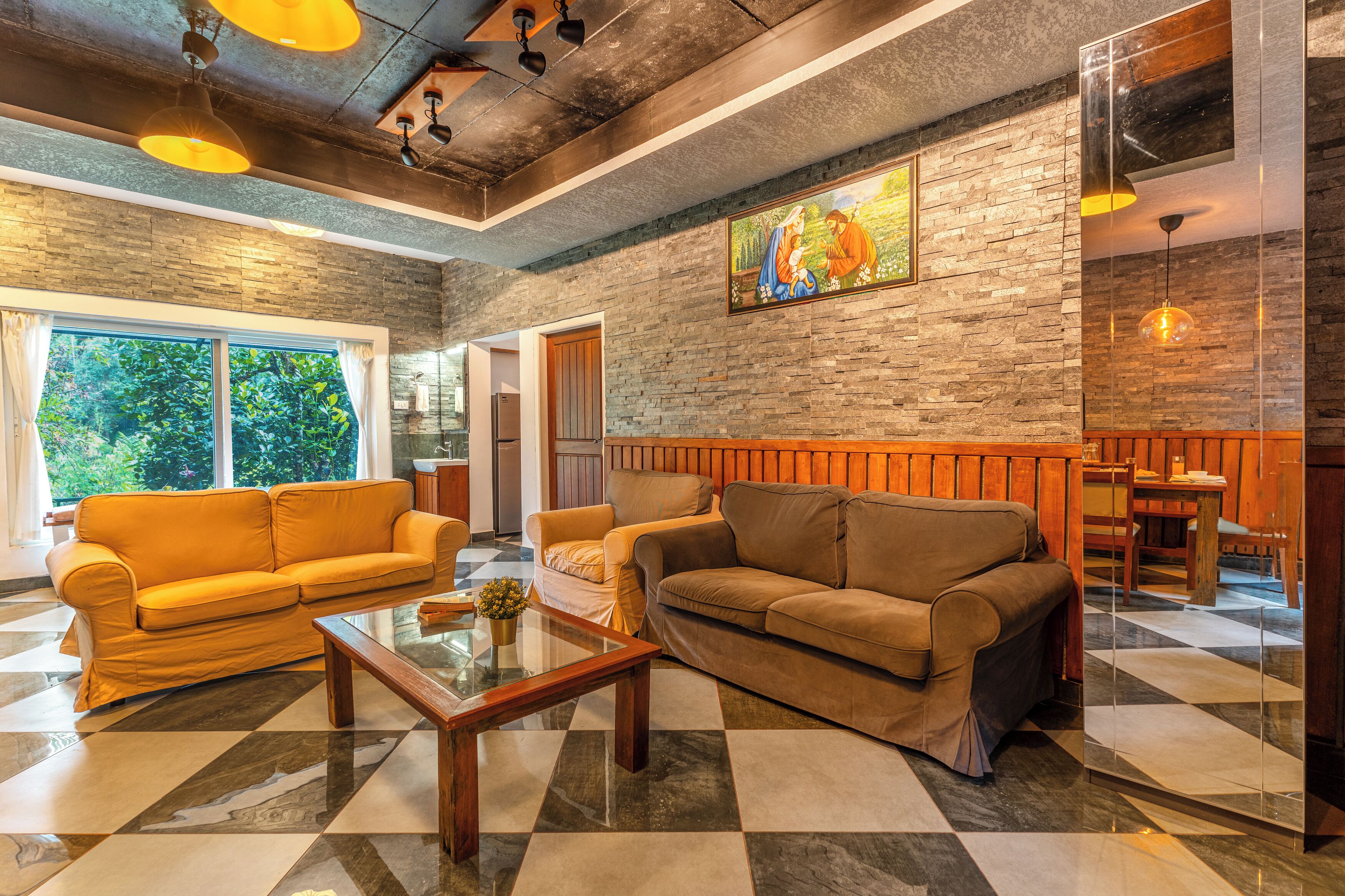 A modern interior with a checkered floor, two sofas, a coffee table, and a painting on the wall.