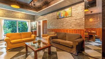 A modern interior with a checkered floor, two sofas, a coffee table, and a painting on the wall.