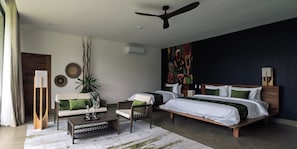A modern bedroom with a large bed, a sofa, a coffee table, and a ceiling fan. - Niyara - Contemporary African Hotel (Arusha)