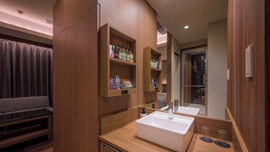 A modern bathroom with a large mirror, a white sink, and wooden cabinetry. - HOTEL TWIN FLAG (Ichikawa)