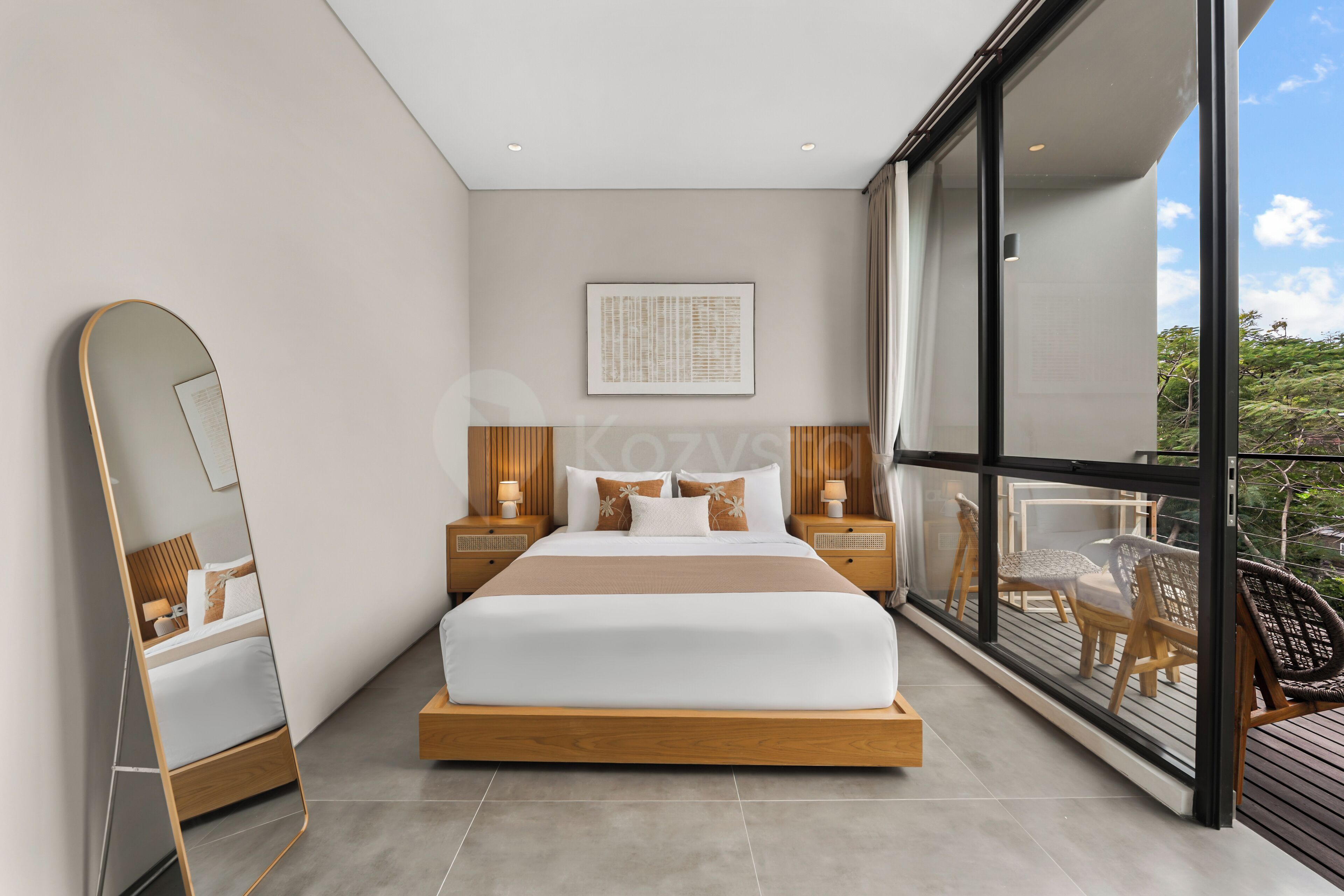 A modern bedroom with a large bed, bedside tables, a mirror, and a view of the outdoors.
