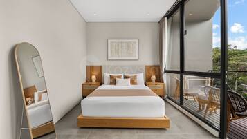A modern bedroom with a large bed, bedside tables, a mirror, and a view of the outdoors.