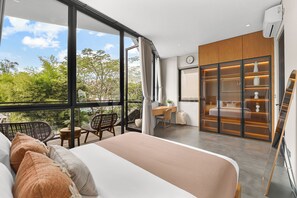 A modern bedroom with a large window, a bed, a desk, and a wardrobe.