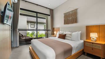 A modern hotel room with a large bed, a bedside table with a lamp, a TV mounted on the wall, and a view of the outside balcony.
