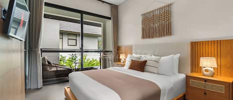 A modern hotel room with a large bed, a bedside table with a lamp, a TV mounted on the wall, and a view of the outside balcony.