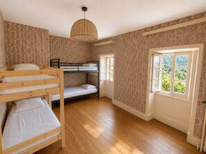 A room with a bunk bed, a single bed, a window with a view, and a woven light fixture. - Country house in the heart of the Ardèche, near Valence, with mountain views (Saint-Laurent-du-Pape)