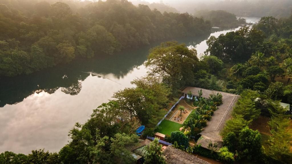 Una propiedad tranquila junto al lago con vista despejada al agua, rodeada de exuberante vegetación.