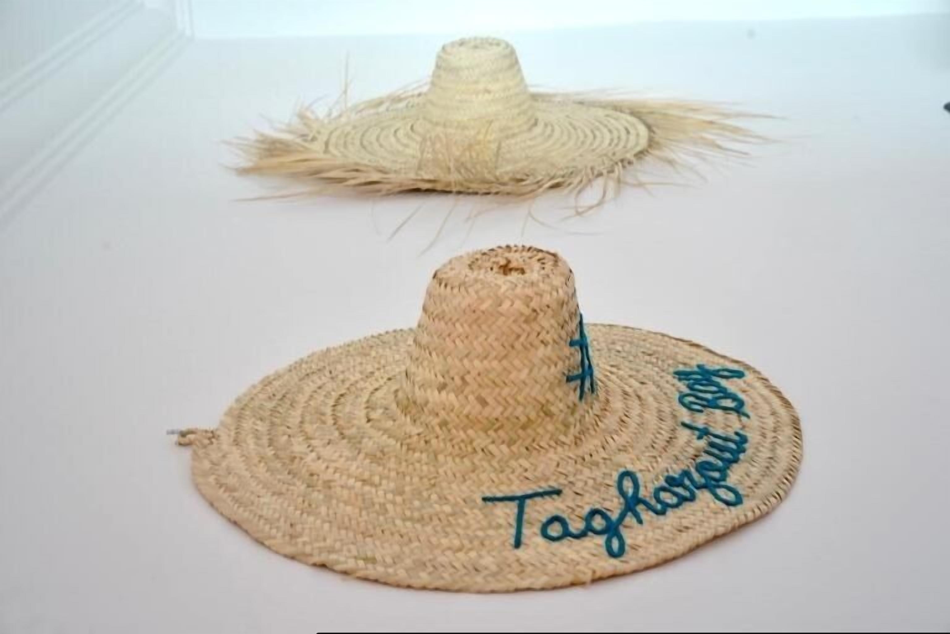 Two woven hats with text on them.