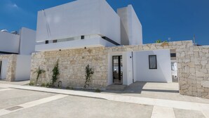 A modern building with a stone facade and a flat roof. - New, 4 Bedroom Villa With Pool, 100 Meters From the Beach (Paralimni)