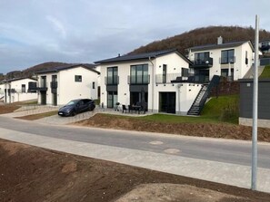 A modern residential building with a flat roof, large windows, and a staircase leading to a second floor. - SEEside13. Lake view. Sauna. Front Row at Diemelsee (Diemelsee)