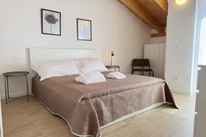 A bedroom with a bed, a bedside table, a chair, and a wardrobe. - [Il Parco Apartment 7] Natura & Relax-RoadTo5Terre (Beverino)