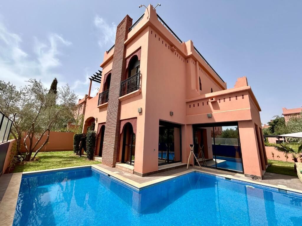 A two-story building with a swimming pool in front.