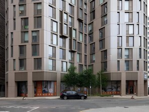 A multi-story building with a modern architectural design, featuring a series of windows and a car parked in front. - Student Only Felda House Wembley (Wembley)