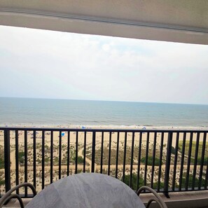 A balcony with a view of a beach and ocean. - Enjoy beautiful oceanfront views of the Ocean City coastline in this one bedroom, one bath condo located just a few steps from the beach! (Ocean City)