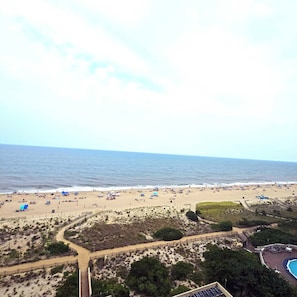 A beach with a fenced area, a swimming pool, and a clear view of the ocean. - Enjoy beautiful oceanfront views of the Ocean City coastline in this one bedroom, one bath condo located just a few steps from the beach! (Ocean City)