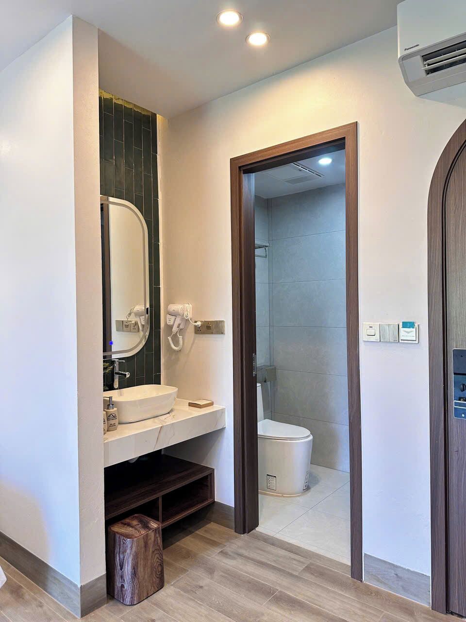 A modern bathroom with a vanity, mirror, and shower.
