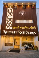 A building with a sign reading 'Kumari Residency' and a tree logo above the entrance.
