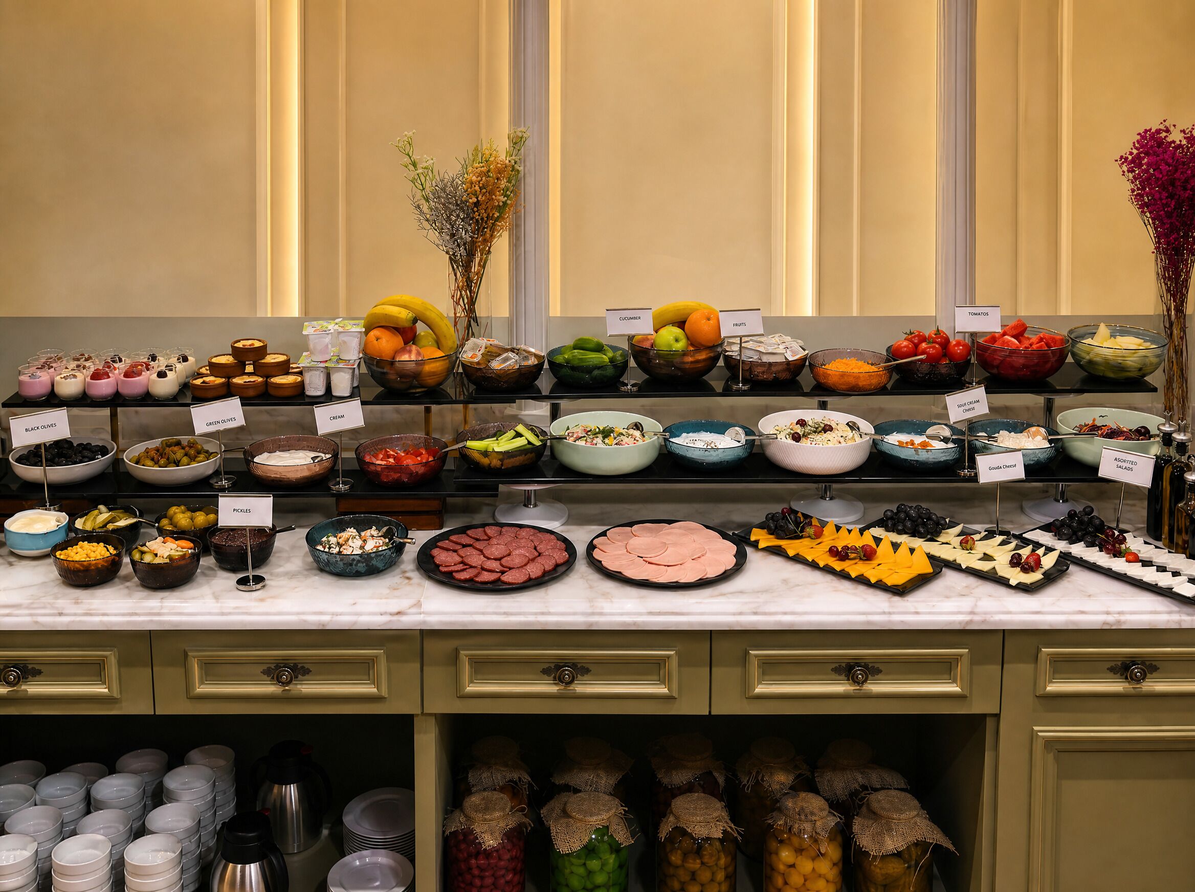 A buffet with various food items and labels.