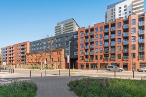 A multi-story residential building with balconies, a pedestrian pathway, and a clear sky. - City Center | Bastion Wałowa 59 with Balcony (Gdańsk)