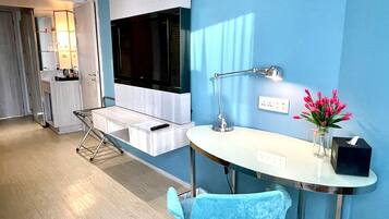 A modern bathroom with a white vanity, a mirror, a sink, and a shower area.