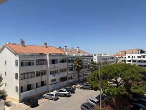 A multi-story residential building with a parking lot in front. - Gale Beach Walk T3 Apartment (Albufeira)