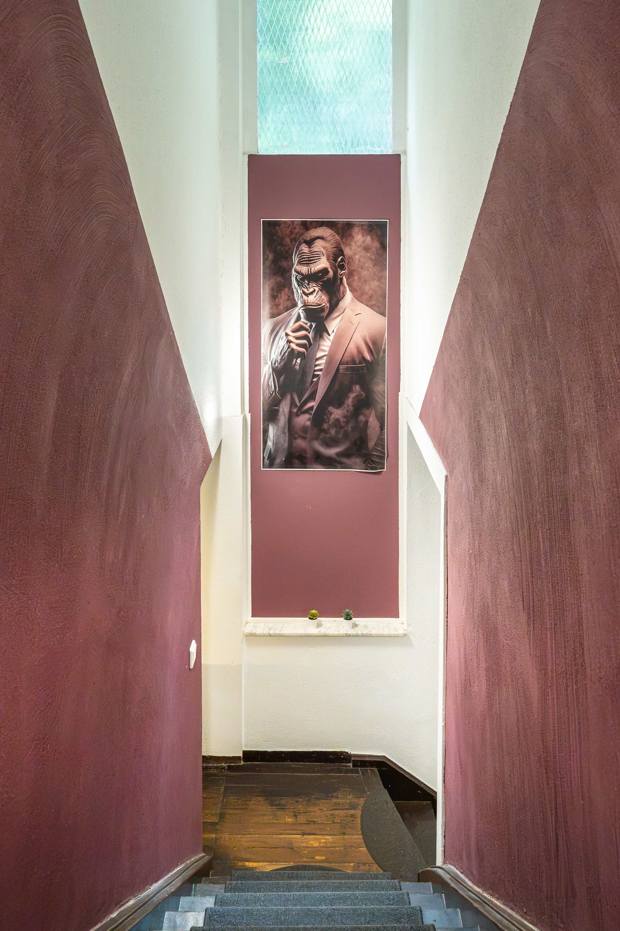 A staircase with a poster of a man in a suit.
