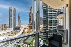 A high-rise building with multiple balconies, a view of a road with vehicles, and a clear sky. - Amazing 1BR | Steps to Marina Walk, Near JBR Beach (Dubai)