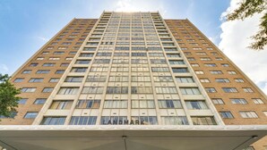 A high-rise building with a prominent 'LANDMARK' sign at the entrance. - Downtown Atlanta High-rise Condo (Atlanta)