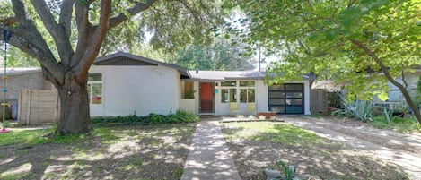A residential house with a front yard, a driveway, and a garage.