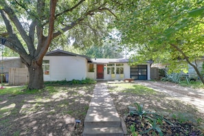 A residential house with a front yard, a driveway, and a garage. - Mid-term Stay in Austin! Family Home w/ Backyard (Austin)