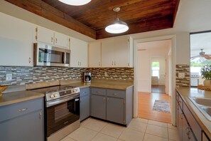A modern kitchen with a built-in microwave, stainless steel appliances, and a wooden ceiling. - Lanai, Golf Views! Extended Sarasota Stay (Sarasota)