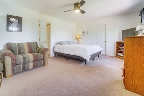 A bedroom with a bed, a chair, a desk, and a ceiling fan. - Grand Junction Home w/ Patio: Shop, Dine & Hike! (Grand Junction)