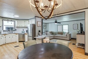 A modern kitchen with white cabinets, a built-in oven, and a stainless steel refrigerator. - 4-passenger Golf Cart! Fun in the Villages (Lady Lake)