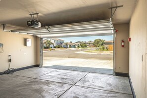 A garage with a clear view of a residential street and houses.