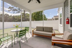 A covered patio with a table, chairs, and a sofa. - May River Fun! Home 9 Mi to Hilton Head Island (Bluffton)